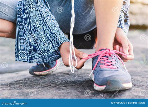 close  girl hands tying shoelace  shoes stock photo image