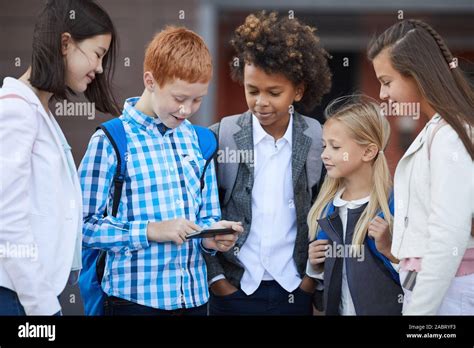 Group Of Multiethnic School Children Playing Online Games On Mobile