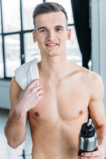 Premium Photo Handsome Shirtless Sportsman Holding Sports Bottle And