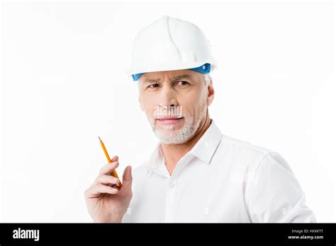 Mature Male Architect In Hard Hat Holding Pencil On White Stock Photo