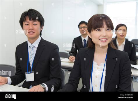 Business People Listening Attentively To Presentation Stock Photo Alamy