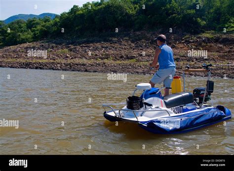 An Angler On An Aquaquad Boat Casts For Tiger Fish In Pretty Lake