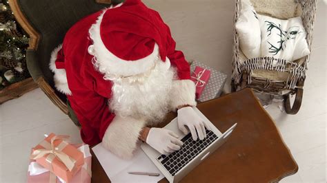 Busy Santa Claus Preparing Presents Using Laptop Stock Video Footage