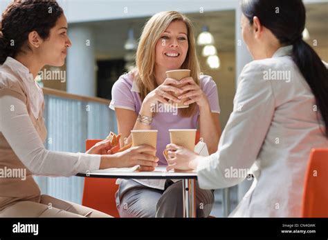 Office Workers Enjoying Meal In Office Cafe Stock Photo Alamy