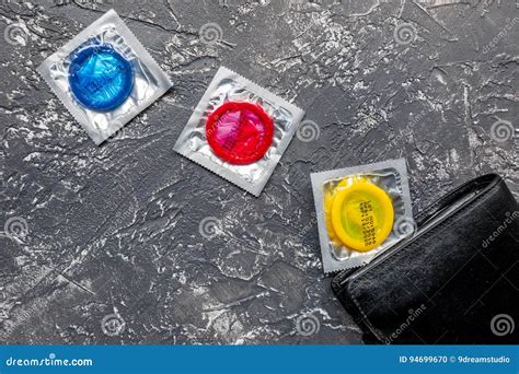 Male Contraception For Safe Sex With Condoms In Wallet On Dark