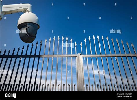 Modern Security Camera Monitoring The Entrance To A Gate Of A Private