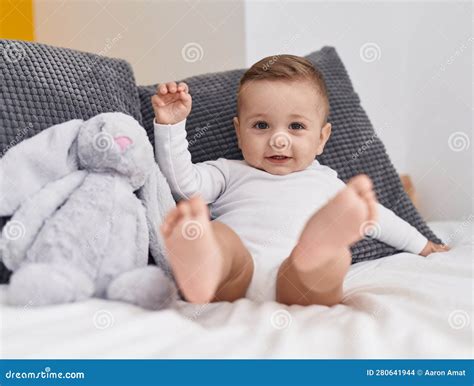 Adorable Caucasian Baby Smiling Confident Sitting On Bed At Bedroom