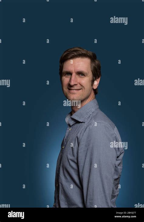 Smiling Man with Head Turned Towards Camera Stock Photo - Alamy