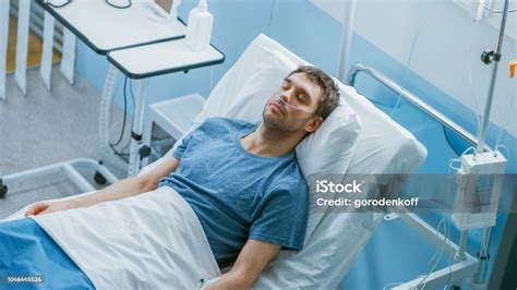 In The Hospital Sick Male Patient Sleeps On The Bed Hes Wearing Nasal