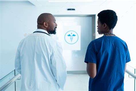 Rear View Of African American Male And Female Doctor Talking In