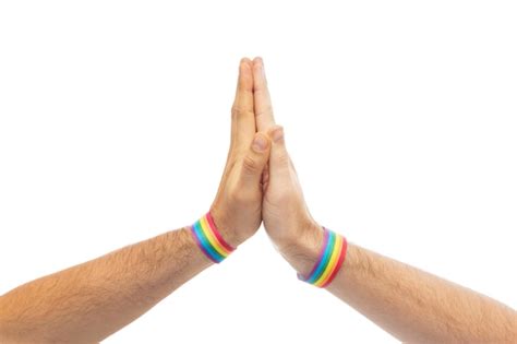 Premium Photo Hands With Gay Pride Wristbands Make High Five