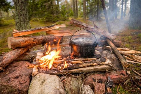 Bushcraft Setting with a Camping Pot on a Burning Fire. Stock Image ...