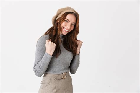 Premium Photo Portrait Of Brunette Woman Wearing Hat Smiling And Clenching Fists Isolated Over