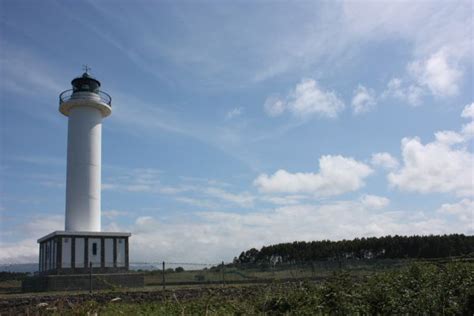 Free Images Sea Coast Rock Lighthouse White Blue Sky Close Up