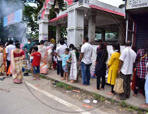 Image Of Devotees Stand In Queue Outside A Ganesh Temple To Offer