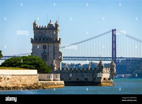 Scenic Belem Tower And Wooden Bridge Miroring With Low Tides On Tagus