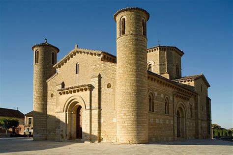 An Old Stone Building With Two Towers