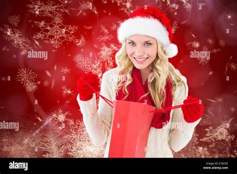 Composite Image Of Happy Festive Blonde With Shopping Bag Stock Photo