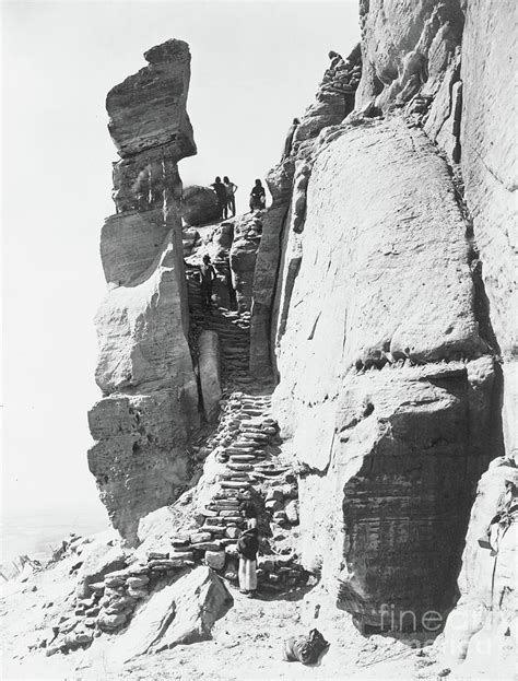 Hopi Indians Along Steps Up Rocks Leading To Pueblo On Mesa Walpi