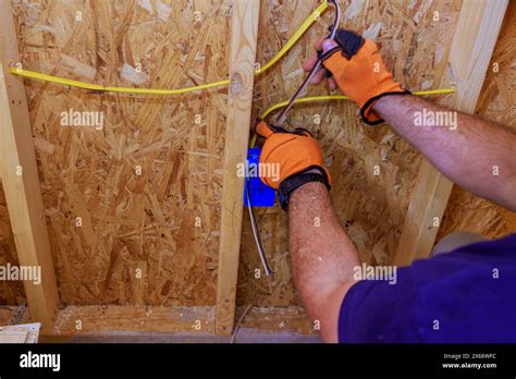 An Electrician Installation Of Assembled Electrical Wires On Interior Work Residential