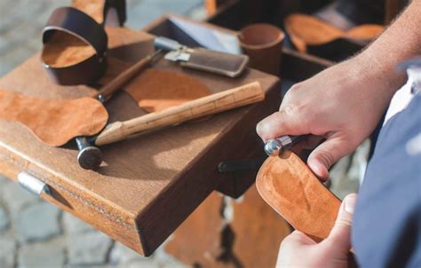 Premium Photo Close Up Of Shoemaker Making Sandal At Workshop