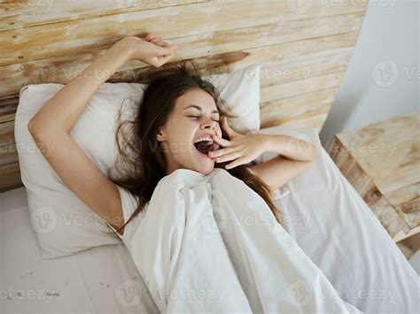 Woman Lying In Bed Waking Up After Sleep Yawning Good Morning 23614401