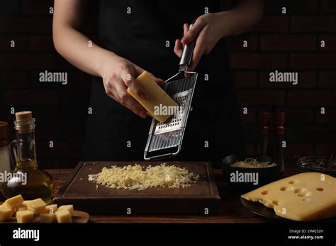 Woman Grating Cheese At Wooden Table Closeup Stock Photo Alamy