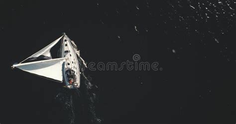 Top Down Aerial Of Sailing Yacht At Sun Reflection In Open Sea Ocean