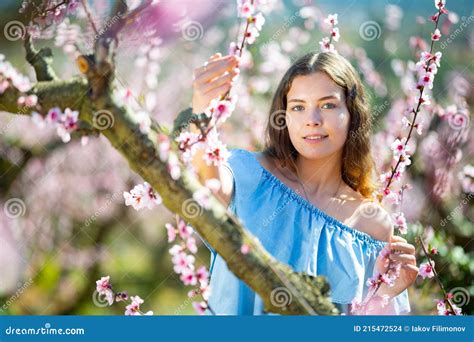 Beautiful Blonde Girl With Long Hair In A Pink Dress In Blooming Garden Stock Photo Image Of