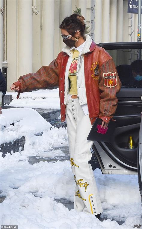 Bella Hadid Shows Off Her Abs As She Frolics Through The Snow In Pants With The Word Sex On