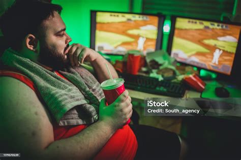 Overweight Man Gamer Playing Video Games On Computer Stock Photo