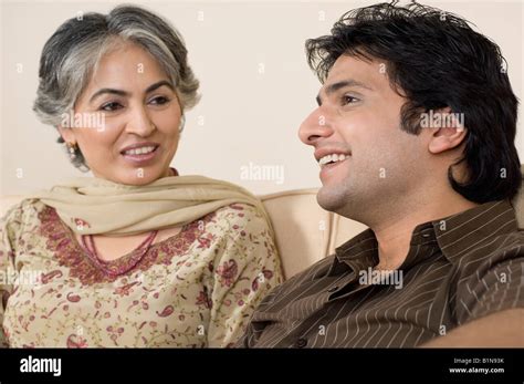 Close Up Of A Mature Woman And Her Son Sitting On A Couch Stock Photo Alamy
