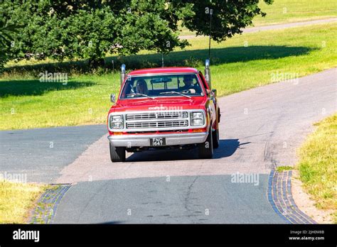 Front View Of Red Classic American Dodge D150 Pickup Truck 1979 Driving