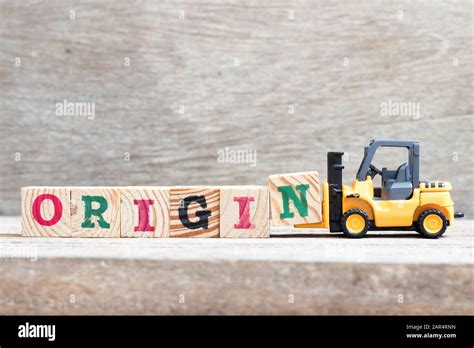 Toy Forklift Hold Letter Block N To Complete Word Origin On Wood