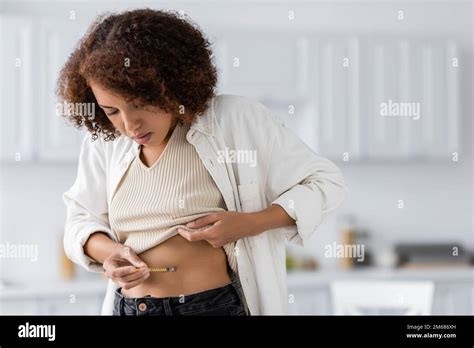 Curly African American Woman With Diabetes Doing Injection Of Insulin