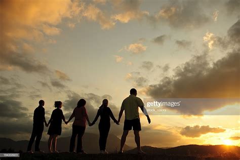 Two Best Friends Holding Hands In The Sunset