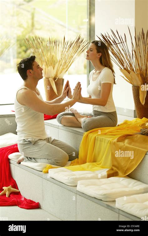 Mid Adult Couple Meditating Stock Photo Alamy