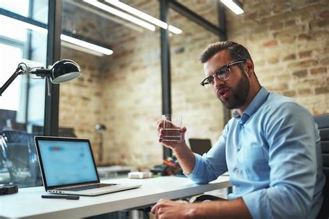 Premium Photo Refreshing Thirsty Bearded Businessman In Eyeglasses