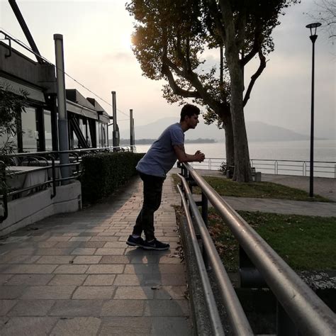 Premium Photo Full Length Of Man Leaning On Railing At Promenade