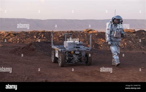 An Analog Astronaut Clad In A Specialized Spacesuit Walks Around A