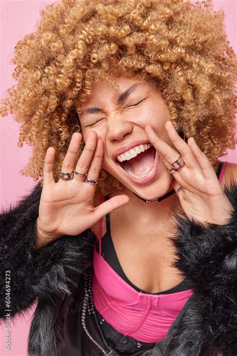 Vertical Shot Of Emotional Curly Haired Adult European Woman Keeps