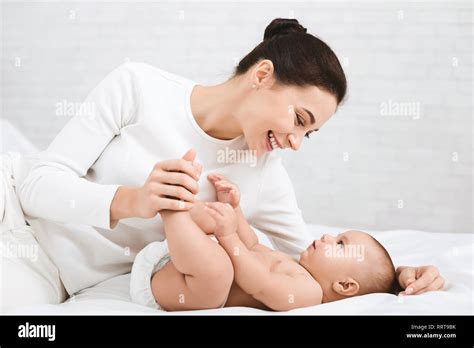 Mother Playing With Her Baby In Bedroom Stock Photo Alamy