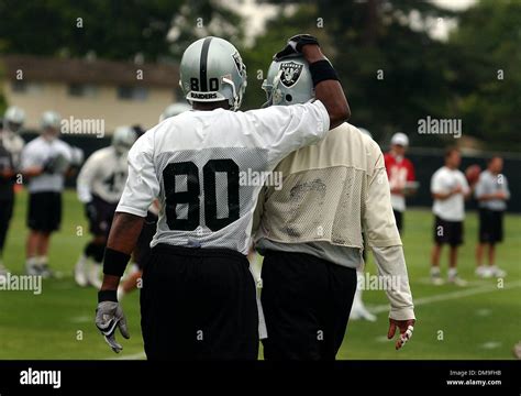 Jerry Rice (left) embraces teammate Tim Brown (right) during the Raiders Friday morning practice ...