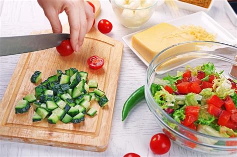 Premium Photo Female Hands Cutting Vegetables For Salad At Kitchen