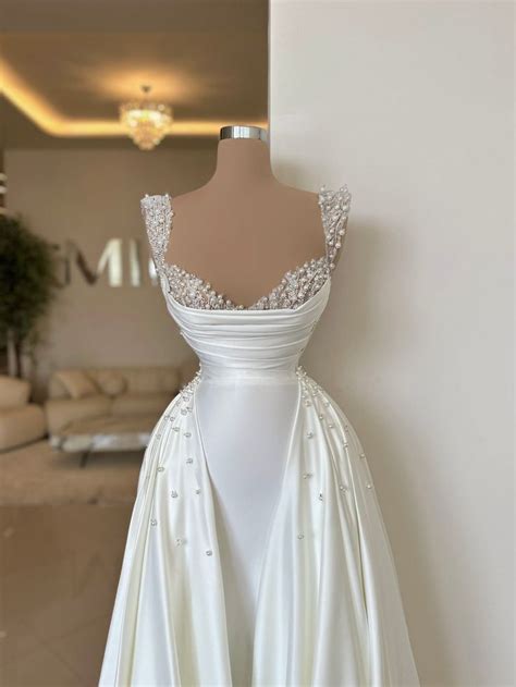 A White Wedding Dress On Display In A Room