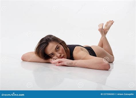 Asian Woman With Long Hair Posing In Black Lingerie On White Background