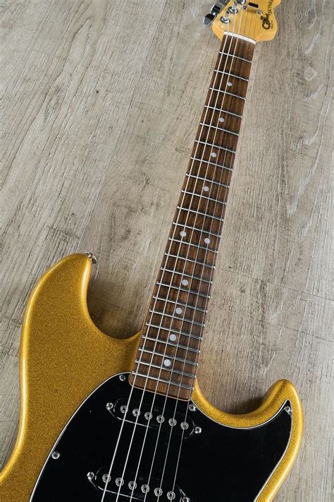 An Electric Guitar Sitting On Top Of A Wooden Floor