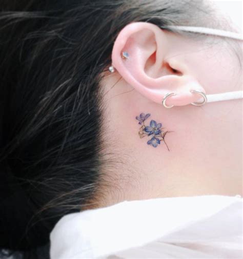 Tiny Blue Flower Tattoo Behind The Ear