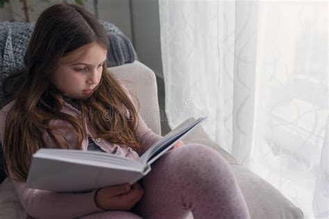 Child Reading a Book, at Home by the Window. Stock Photo - Image of ...