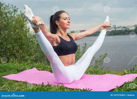 Woman Holding Legs Apart Doing Exercises Aerobics Warming Up With Gymnastics For Flexibility Leg